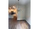 Open-concept dining area with a stylish chandelier and hardwood floors throughout at 6424 Rosetta Dr, South Fulton, GA 30331