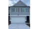 Charming townhome with gray siding, gray shutters, and a two-car garage at 6424 Rosetta Dr, South Fulton, GA 30331
