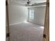 Spacious main bedroom featuring neutral carpet, a ceiling fan, and a window for natural light at 6424 Rosetta Dr, South Fulton, GA 30331