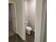 Powder room featuring a toilet and wood-look floors at 6424 Rosetta Dr, South Fulton, GA 30331