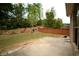 Landscaped backyard with well-maintained lawn, wooden fence, and patio at 1142 Terrasol Rdg, Lilburn, GA 30047
