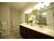 Bathroom with double vanity, white countertops, framed mirror, and tiled shower with glass door at 1142 Terrasol Rdg, Lilburn, GA 30047