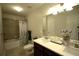 Bright bathroom with double sinks, vanity, tub, and a decorative mirror at 1142 Terrasol Rdg, Lilburn, GA 30047