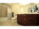 Cozy bathroom with shower-tub, dark wood cabinets, and double sinks at 1142 Terrasol Rdg, Lilburn, GA 30047
