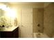 Well-lit bathroom with tiled shower and tub combination, offering a fresh look at 1142 Terrasol Rdg, Lilburn, GA 30047