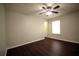 Bedroom boasts ceiling fan and hardwood floors complemented by natural light at 1142 Terrasol Rdg, Lilburn, GA 30047