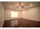 Bright and airy bedroom with a tray ceiling, neutral walls, and dark wood floors at 1142 Terrasol Rdg, Lilburn, GA 30047