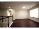 Upstairs bonus room with neutral walls, wood-look flooring, and lots of natural light at 1142 Terrasol Rdg, Lilburn, GA 30047