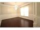 Formal dining room with dark wood floors, chandelier lighting, and wainscoting at 1142 Terrasol Rdg, Lilburn, GA 30047