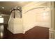 Foyer featuring dark wood floors, white wainscoting, archway, and chandelier at 1142 Terrasol Rdg, Lilburn, GA 30047
