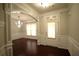 Foyer with dark wood flooring, elegant lighting, and stylish wall paneling at 1142 Terrasol Rdg, Lilburn, GA 30047
