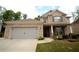 Charming two-story brick home with a well-manicured front yard and attached two car garage at 1142 Terrasol Rdg, Lilburn, GA 30047