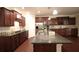 Beautiful kitchen with dark wood cabinets, stainless steel appliances, and granite countertops with dark wood floors at 1142 Terrasol Rdg, Lilburn, GA 30047