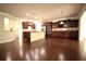 Spacious kitchen with dark wood cabinets, stainless steel appliances, and center island with dark wood floors at 1142 Terrasol Rdg, Lilburn, GA 30047