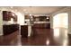 Spacious kitchen featuring dark wood cabinets, stainless steel appliances and a kitchen island with dark wood floors at 1142 Terrasol Rdg, Lilburn, GA 30047
