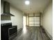 This kitchen-garage combo showcases a stove, overhead fan, and garage door access at 1142 Terrasol Rdg, Lilburn, GA 30047