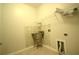 Functional laundry room with sink and storage shelving, perfect for organization at 1142 Terrasol Rdg, Lilburn, GA 30047