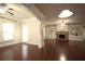 Bright living room featuring hardwood floors, a fireplace, and an open floor plan at 1142 Terrasol Rdg, Lilburn, GA 30047