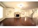 Bright living room features a cozy stone fireplace, built-in shelving, and a staircase at 1142 Terrasol Rdg, Lilburn, GA 30047
