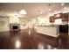 An expansive living room with hardwood floors flowing into the kitchen and dining area at 1142 Terrasol Rdg, Lilburn, GA 30047