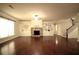 Spacious living room with a stone fireplace, custom built-ins, and dark hardwood floors at 1142 Terrasol Rdg, Lilburn, GA 30047