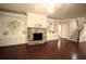 Comfortable living room with a stone fireplace, custom shelving, and hardwood floors at 1142 Terrasol Rdg, Lilburn, GA 30047