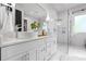 Stylish bathroom with dual sinks, modern fixtures, and a glass-enclosed shower at 1188 Woodtrace Ln, Auburn, GA 30011