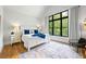 Cozy bedroom with a large window, natural light, and backyard views, complemented by hardwood floors and tasteful decor at 1188 Woodtrace Ln, Auburn, GA 30011