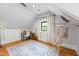 Attic bedroom with hardwood floors, a hammock, and a built-in desk area, perfect for a cozy retreat at 1188 Woodtrace Ln, Auburn, GA 30011