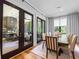 Bright dining room featuring hardwood floors, a large wooden table and seating for eight at 1188 Woodtrace Ln, Auburn, GA 30011