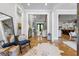 Inviting entryway featuring hardwood floors, an area rug, with views into the living room and kitchen at 1188 Woodtrace Ln, Auburn, GA 30011