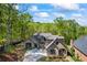 Beautiful exterior elevation of a stone home with mature landscaping, brick accents, and a circular driveway at 1188 Woodtrace Ln, Auburn, GA 30011