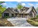 Beautiful home featuring stone and brickwork with a three-car garage and large driveway at 1188 Woodtrace Ln, Auburn, GA 30011