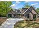 Stunning brick and stone home with a spacious driveway and a three-car garage at 1188 Woodtrace Ln, Auburn, GA 30011