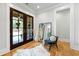 Elegant foyer with hardwood floors, a statement mirror, and French doors leading to the outside at 1188 Woodtrace Ln, Auburn, GA 30011
