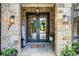 Charming front entryway with stone accents, double doors, and welcoming decor at 1188 Woodtrace Ln, Auburn, GA 30011