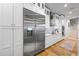 Modern kitchen featuring stainless steel refrigerator, white cabinets, and hardwood flooring at 1188 Woodtrace Ln, Auburn, GA 30011