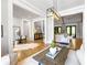 Open-concept living room showcasing hardwood floors, neutral decor, and elegant lighting at 1188 Woodtrace Ln, Auburn, GA 30011