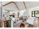 Spacious living room with vaulted ceilings, exposed beams, hardwood floors, and an open floor plan to the kitchen at 1188 Woodtrace Ln, Auburn, GA 30011