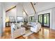 Inviting living room with vaulted ceilings, exposed wood beams, a fireplace, and French doors to the outdoors at 1188 Woodtrace Ln, Auburn, GA 30011