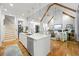 Open-concept living space with vaulted ceilings, hardwood floors, and a modern kitchen island at 1188 Woodtrace Ln, Auburn, GA 30011