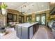 Outdoor kitchen with brick accents, a spacious island, and covered patio with seating and grilling area at 1188 Woodtrace Ln, Auburn, GA 30011