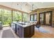 Covered outdoor kitchen featuring a granite countertop island, seating, and brick accents at 1188 Woodtrace Ln, Auburn, GA 30011