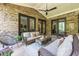 Covered patio with comfortable seating, a ceiling fan, and access to the backyard at 1188 Woodtrace Ln, Auburn, GA 30011