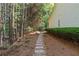 Stone path leading through a wooded area alongside the house at 1315 Badingham Dr, Cumming, GA 30041