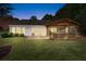 A well-maintained backyard with a screened porch and patio with seating offers a cozy outdoor retreat at 1315 Badingham Dr, Cumming, GA 30041