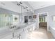 Bright bathroom with double vanity, large mirror, glass enclosed shower, and a view to the bedroom at 1315 Badingham Dr, Cumming, GA 30041