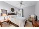 Cozy bedroom with a queen-size bed, decorative mirror, ceiling fan, and neutral paint at 1315 Badingham Dr, Cumming, GA 30041