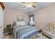 Comfortable bedroom with a full-size bed, wood furniture, and a charming floral chair at 1315 Badingham Dr, Cumming, GA 30041