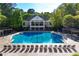 Upscale community pool and clubhouse with lounge chairs and manicured landscaping at 1315 Badingham Dr, Cumming, GA 30041